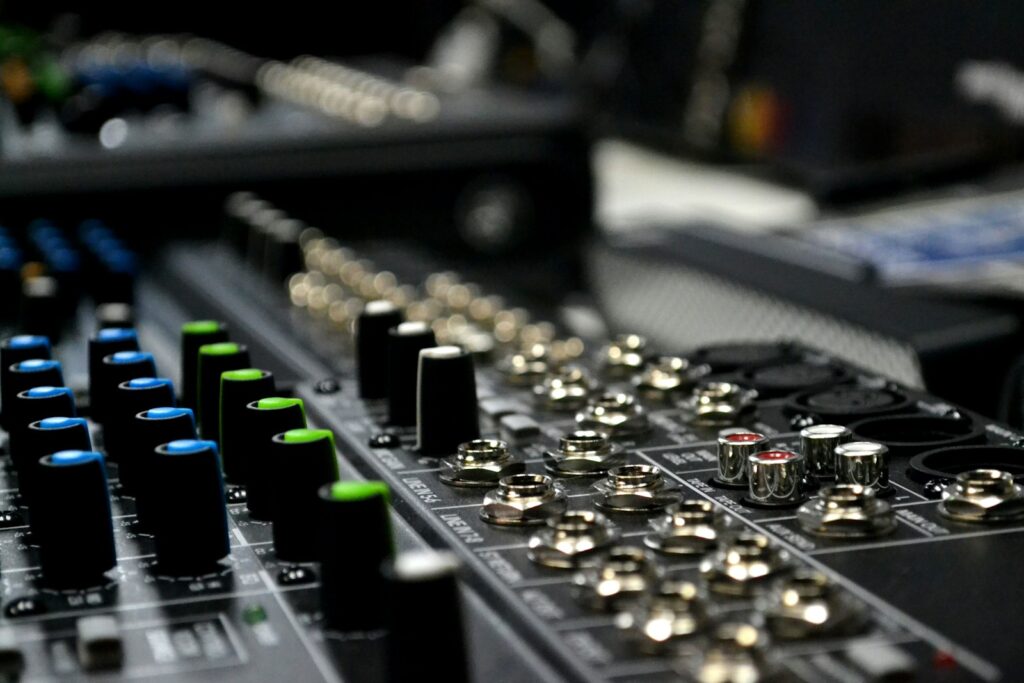A close up of a sound mixing console